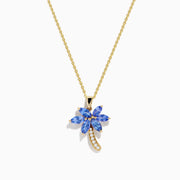The Nahla Siri 14K Yellow Gold Tanzanite and Diamond Palm Tree Pendant features marquise-cut blue tanzanite leaves and sparkling diamonds accenting the curved trunk for added brilliance.