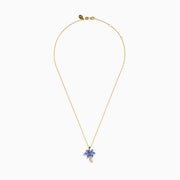 The Nahla Siri 14K Yellow Gold Tanzanite and Diamond Palm Tree Pendant features marquise-cut blue tanzanite leaves and sparkling diamonds accenting the curved trunk for added brilliance.