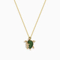 The Seaside 14K Yellow Gold Tsavorite and Diamond Turtle Pendant showcases a large turtle with a tsavorite shell and a smaller diamond-encrusted turtle, both suspended from a delicate gold chain.