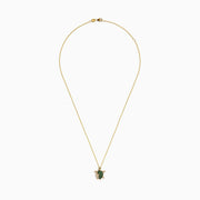 The Seaside 14K Yellow Gold Tsavorite and Diamond Turtle Pendant showcases a large turtle with a tsavorite shell and a smaller diamond-encrusted turtle, both suspended from a delicate gold chain.