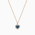 The Bella Bleu 14K Rose Gold Blue and White Diamond Heart Pendant features a heart-shaped design with blue diamonds at the center, bordered by white diamonds, hanging vertically on a rose gold chain against a white background.