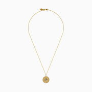 Signature 14K Yellow Gold Diamond and Emerald Panther Pendant features a round medallion with sparkling diamonds, emerald accents, and a delicate gold chain. Displayed against a white background.