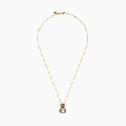 The Signature 14K Yellow Gold Diamond and Enamel Panther Pendant features a sparkling diamond-adorned circular ring gripped by a black and gold panther head, hanging from an elegant chain.