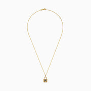 The Signature 14K Yellow Gold Diamond Lock Pendant features a jeweled panther face with green eyes, black accents, and small clear crystals on the loop, all on a yellow gold chain necklace.