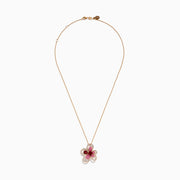 The Nature 14K Rose Gold Rhodolite Pink Sapphire and Diamond Flower Pendant features a central red rhodolite gemstone, surrounded by pink sapphires and diamonds outlining its elegant flower petals.