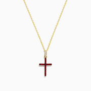 The Novelty 14K Yellow Gold Ruby and Diamond Cross Pendant features a vibrant ruby cross accented with red gemstones and a touch of clear diamonds at the top, all on a yellow gold chain necklace.