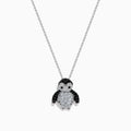 A 14K white gold necklace featuring a penguin pendant accented with diamonds, white sapphires, and black spinel.