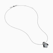 A 14K white gold necklace featuring a penguin pendant accented with diamonds, white sapphires, and black spinel.