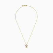 The Signature 14K Yellow Gold Diamond and Rhodium Panther Pendant features black and green details and a circular gold ring in the panther’s mouth.