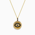 The Novelty 14K Yellow Gold Black and White Diamond Evil Eye Pendant features a round charm with black and white diamonds forming an eye, accented by a border of small clear stones.