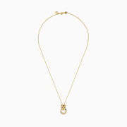 The Signature 14K Yellow Gold Diamond and Emerald Panther Pendant features a stylized panther head with green gemstone eyes and a circular ring adorned with sparkling diamonds.