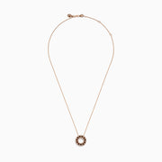 The 14K Rose Gold Brown and White Diamond Circle Pendant features alternating brown and white diamonds in a circle on a delicate gold chain, displayed against a white background.