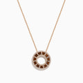 The 14K Rose Gold Brown and White Diamond Circle Pendant features alternating brown and white diamonds in a circle on a delicate gold chain, displayed against a white background.