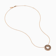 The 14K Rose Gold Brown and White Diamond Circle Pendant features alternating brown and white diamonds in a circle on a delicate gold chain, displayed against a white background.