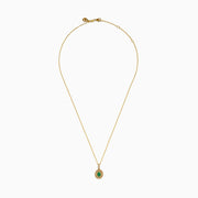 The 14K Yellow Gold Emerald and Diamond Filigree Halo Pendant features an elegant oval green emerald encircled by sparkling diamonds, with additional diamond accents on the bail for added brilliance.