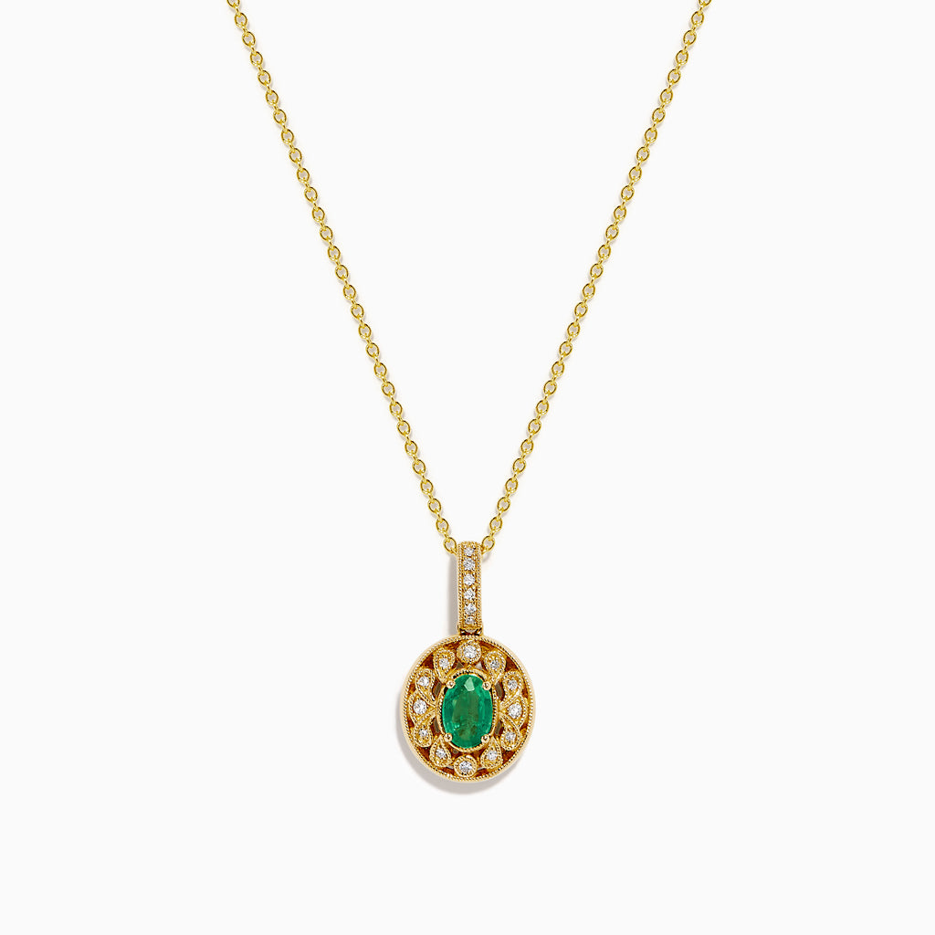 The 14K Yellow Gold Emerald and Diamond Filigree Halo Pendant features an elegant oval green emerald encircled by sparkling diamonds, with additional diamond accents on the bail for added brilliance.