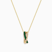The 14K Yellow Gold Emerald and Diamond Crossover Pendant features interwoven bands—one set with emeralds, the other with sparkling diamonds—on a delicate gold chain for an elegant effect.