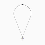 The 925 Silver Tanzanite and Diamond Dolphin Pendant features tanzanite-blue gems on the body and sparkling diamonds on the tail, elegantly showcased against a white background.