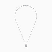 The 14K White Gold Diamond Bezel Halo Pendant features a delicate white gold chain with a round, flower-like diamond pendant, showcasing a central diamond surrounded by a halo of smaller diamonds.