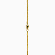 This men's 14K yellow gold dog tag pendant features black onyx, black diamonds, and a modern geometric design with chamfered corners.