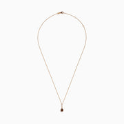 The 14K Rose Gold Pear Halo Brown and White Diamond Pendant features a teardrop-shaped brown and white diamond centerpiece, bordered with sparkling clear stones and accented by a vertical row of clear stones above.