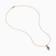 The 14K Rose Gold Blue and White Diamond Pendant features a deep blue oval gemstone with sparkling blue and white diamonds set in a twisting, teardrop-shaped design.