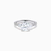 The Star Lab Grown Diamond Ring in 18K White Gold showcases a large round-cut lab diamond center with smaller diamonds along the band, beautifully displayed on a white background.