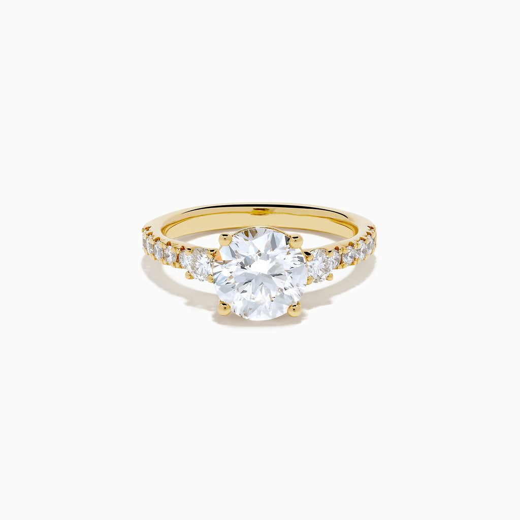 The Star Lab Grown Diamond Ring in 18K yellow gold features a large round center stone with smaller diamonds along the band, shown against a white background.