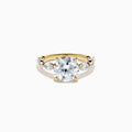 The Star Lab Grown Diamond Ring in 18K Yellow Gold features a large round lab diamond center, accented by three smaller diamonds on each side, all set against a white background.