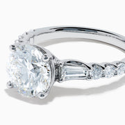 The Star Lab Grown Diamond Ring in 18K White Gold showcases a large oval-cut center stone with baguette and round accents along the band, elegantly presented on a white background.