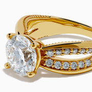 The Star Lab Grown Diamond Embrace Ring in 18K Yellow Gold showcases a prominent round lab-grown diamond center, with rows of smaller diamonds along the band and detailed side designs.