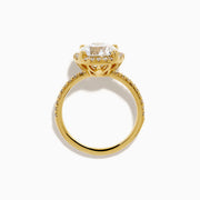 The Star Lab Grown Diamond Halo Ring in 18K Yellow Gold showcases a large oval lab diamond center, encircled by a halo of star lab diamonds and additional diamonds along the band for extra brilliance.