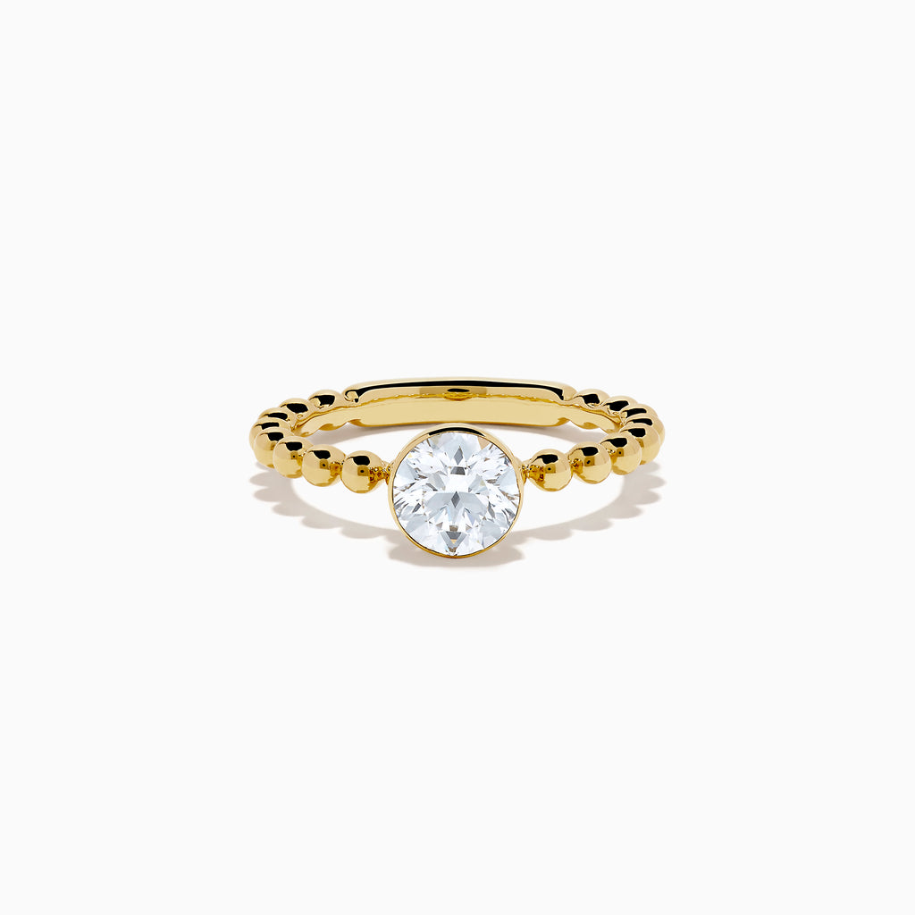 The Star Lab Grown Diamond Moderne Ring in 18K yellow gold features a beaded band and a large round lab diamond at its center, displayed on a white background.