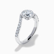 The Star Lab Grown Diamond Connect Ring in 18K White Gold showcases a striking round center stone, with an elegantly twisting band highlighted by sparkling side diamonds for extra brilliance.