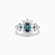 A Platinum GIA Certified Alexandrite and Diamond Starburst Halo Ring, featuring an oval dark blue-green central Alexandrite and sparkling diamond accents, displayed on a white background.