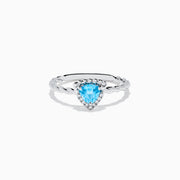 The 925 Sterling Silver Blue Topaz and Diamond Ring features a twisted band, a heart-shaped blue topaz center, and sparkling diamonds, shown against a plain white background.