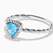 The 925 Sterling Silver Blue Topaz and Diamond Ring features a twisted band, a heart-shaped blue topaz center, and sparkling diamonds, shown against a plain white background.