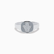 The 925 Sterling Silver Diamond Hamsa Ring features a round face adorned with small clear stones, giving it a sparkling finish.