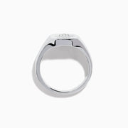 The 925 Sterling Silver Diamond Hamsa Ring features a round face adorned with small clear stones, giving it a sparkling finish.
