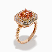 The 14K Rose Gold Morganite and Diamond Geometric Cocktail Ring showcases a large square peach morganite center, framed by two rows of sparkling white diamonds in a geometric halo, set against a white background.