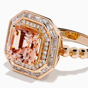 The 14K Rose Gold Morganite and Diamond Geometric Cocktail Ring showcases a large square peach morganite center, framed by two rows of sparkling white diamonds in a geometric halo, set against a white background.