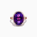 The 14K Rose Gold Amethyst and Diamond Ring showcases an oval amethyst with a diamond halo set on a rose gold band, displayed against a plain white background.