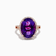 The 14K Rose Gold Amethyst and Diamond Ring showcases an oval amethyst with a diamond halo set on a rose gold band, displayed against a plain white background.