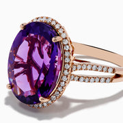 The 14K Rose Gold Amethyst and Diamond Ring showcases an oval amethyst with a diamond halo set on a rose gold band, displayed against a plain white background.
