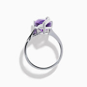 The 14K White Gold Amethyst and Diamond Ring features a large pear-shaped amethyst accented by small diamonds in a curved design, shown on a plain white background.