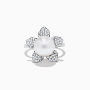 The 14K White Gold Fresh Water Pearl and Diamond Flower Ring features a large pearl at the center, surrounded by five diamond-accented petals on a sleek white gold band.