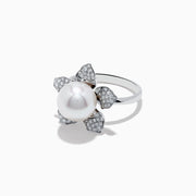 The 14K White Gold Fresh Water Pearl and Diamond Flower Ring features a large pearl at the center, surrounded by five diamond-accented petals on a sleek white gold band.