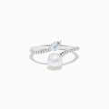 The 14K White Gold Fresh Water Pearl and Diamond By Pass Ring features a round freshwater pearl, a teardrop-shaped diamond, and small diamonds along the band, shown against a plain white background.