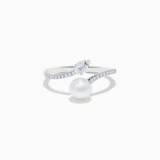 The 14K White Gold Fresh Water Pearl and Diamond By Pass Ring features a round freshwater pearl, a teardrop-shaped diamond, and small diamonds along the band, shown against a plain white background.
