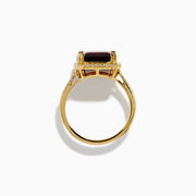 The 14K Yellow Gold Garnet and Diamond Halo Cocktail Ring showcases a large rectangular deep red garnet, surrounded by a diamond halo and diamonds on the band, set against a white background.